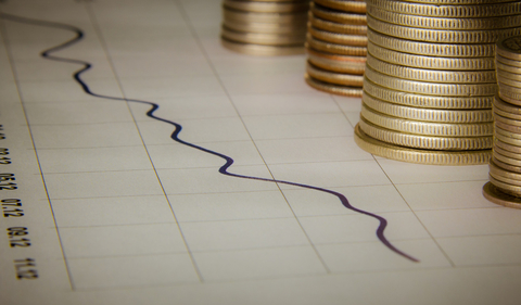 Earnings graph with stacks of coins