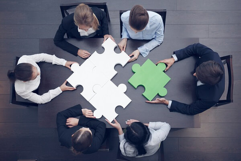 Business executives team teamwork collaboration (Getty/ALotOfPeople) A group of executives work together to solve a puzzle