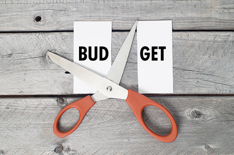 scissors cutting the word "budget" in half
