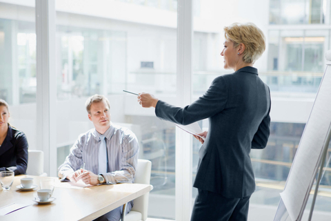 Female executive / businesswoman Female executive leading meeting