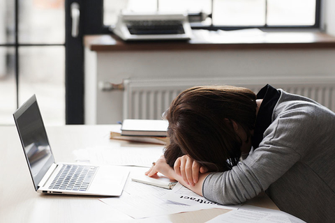 Bad Employee Getty Woman sleeping at desk