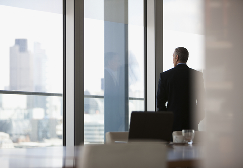 Executive c-suite (Credit: Getty/Tom Merton) Executive looking out window