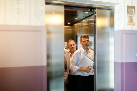 Businessman getting out of elevator Businessman getting out of elevator