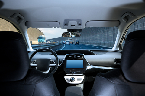 Cockpit of driverless car Cockpit of driverless car driving on highway viewed from rear seat