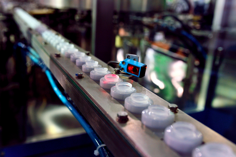 Camera on a production line Camera mounted on conveyor line with product moving past