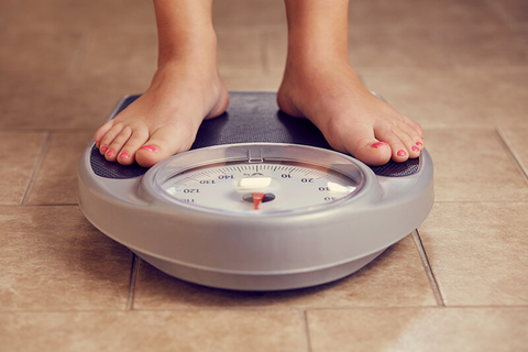 feet on scale weighing // Photo by Rostislav_Sedlacek/iStock/Getty Images Plus/Getty Images feet on scale weighing