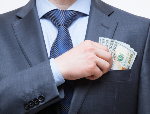 Executive pay (credit: Getty/zest_marina) Businessman putting cash in suit pocket