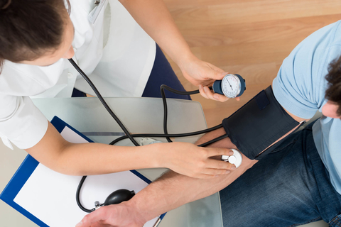 Blood pressure check Doctor checking patient's blood pressure