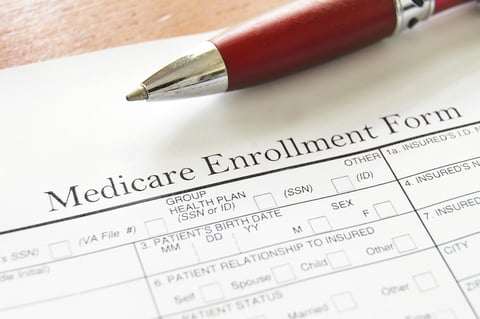 Medicare enrollment form and pen