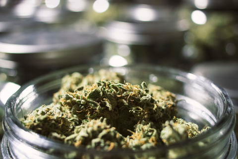 Marijuana buds in a jar with blurry background Marijuana buds in a jar
