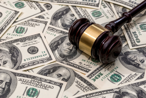 Gavel on top of money Gavel on top of cash