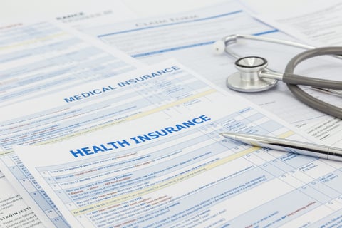Health insurance forms Stack of health insurance application forms with stethoscope on top