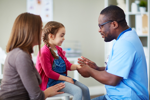 Pediatrician Pediatrician with little girl