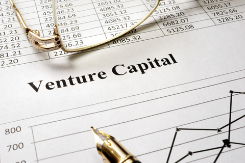 Venture capital investment funding A sheet of paper reading 'venture capital'