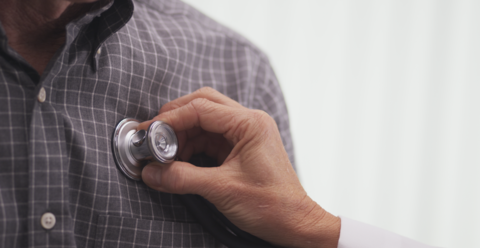 Heart doctor Doctor putting stethescope to patient's chest