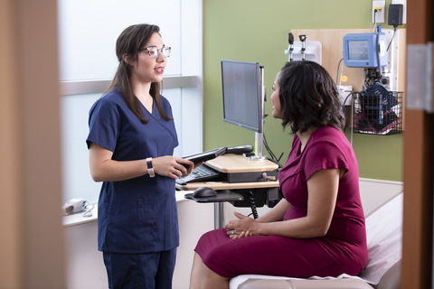 Employer health clinic A woman is treated by a female nurse