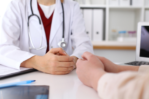 doctor with patient Photo of doctor and patient hands while discussing medical records after health examination