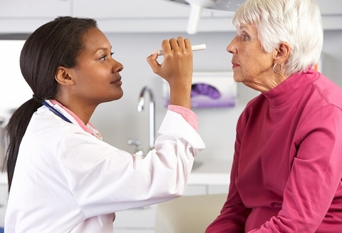 Doctor physician eye exam senior patient healthcare A doctor examining a patient's eyes