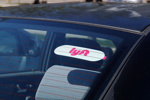 A car window with a Lyft sticker