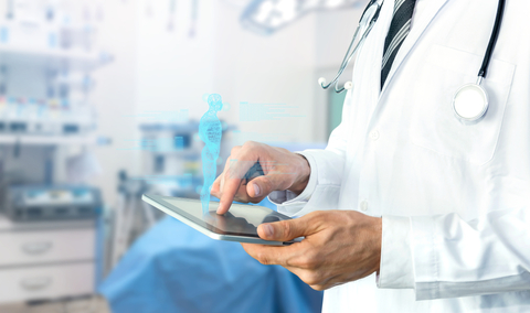 healthcare analytics doctor using tablet in operating room
