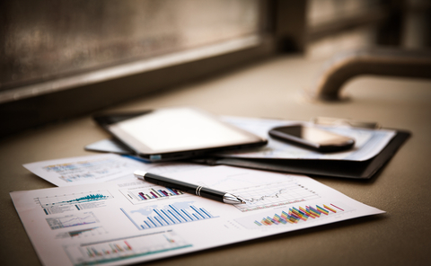 venture capital funding close up of paper documents with business charts and tablet on a table