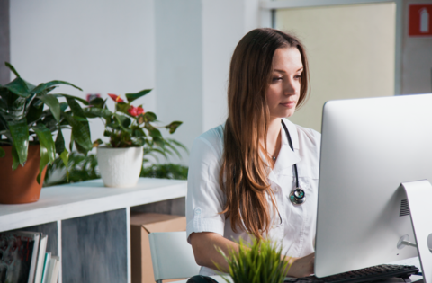 Medical cybersecurity Health professional sitting at a computer