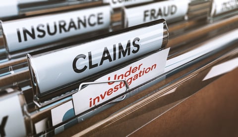 File folders labeled "insurance," "fraud," "claims," and "under investigation"