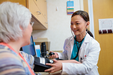 CVS Health Nurse putting blood pressure cuff on older woman's arm at a CVS MinuteClinic