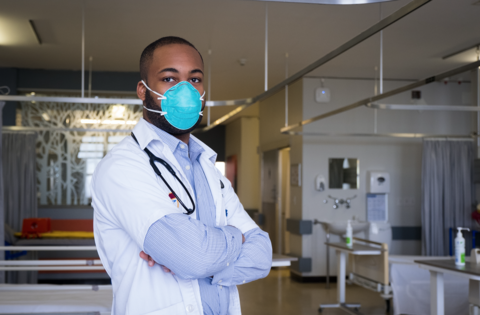 Healthcare worker wearing mask A young male healthcare worker wearing a mask in an emergency room