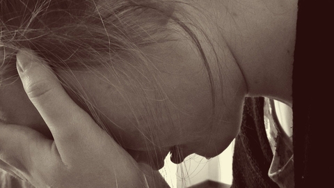 stress woman with face in hands