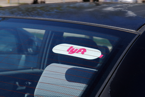 Lyft rideshare A car window with a Lyft sticker