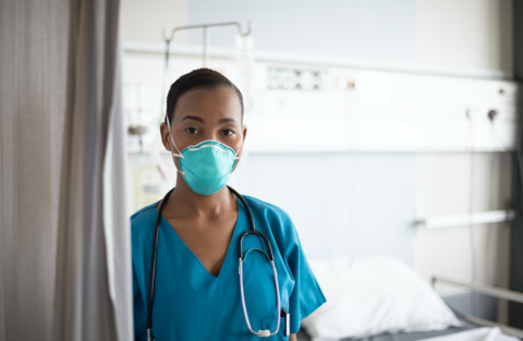 Nurse A female nurse is shown wearing an N95 mask in a hospital room