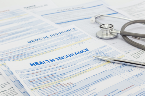Health insurance forms Stack of health insurance application forms with stethoscope on top