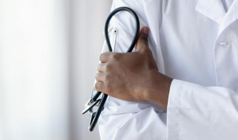 Doctor A doctor crosses his arm while holding a stethescope