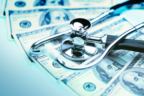 Healthcare costs stethoscope on money