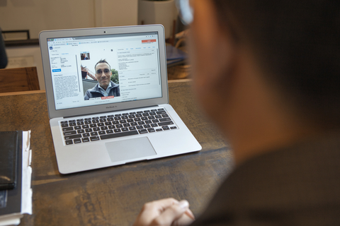 Doctor on Demand virtual visit A doctor sits at a desk and a laptop screen shows a patient interacting with the doctor through a virtual visit