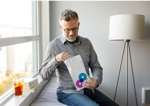 Uber Health Nimble partnership male consumer opens up a Nimble home prescription delivery bag