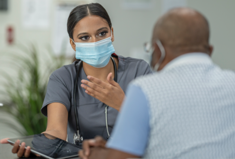 Doctor speaking with a patient A female doctor speaks to a male patient