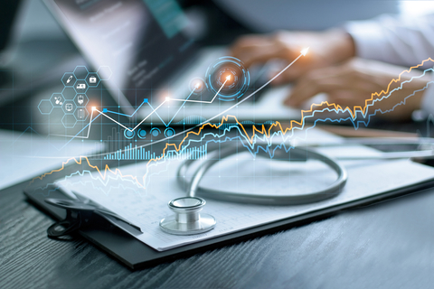 health IT Stethoscope with doctor's health report clipboard on table. Medical examination and doctor analyzing medical report on laptop screen