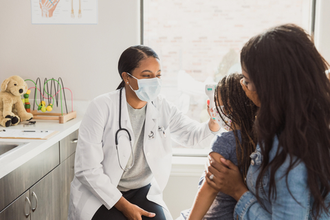 Healthcare diversity Doctor checks patient for fever