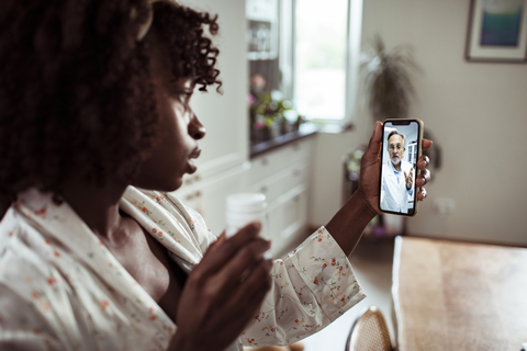 telehealth visit using smartphone young woman consulting with doctor using smartphone for telehealth visit