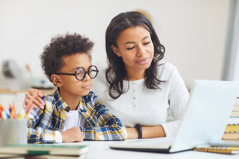 mother and son using laptop for telehealth mother and son using laptop for virtual therapy
