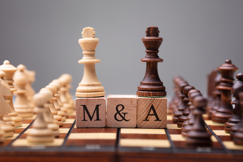 mergers and acquisitions concept of chess board with letters M&A