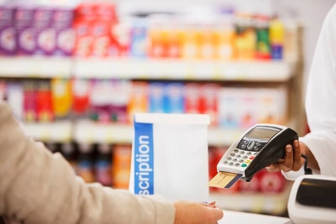 Healthcare costs drug prices prescriptions medication pharma pharmacy benefits credit payment copay (Getty/Tom Merton) Woman paying for a prescription at a pharmacy