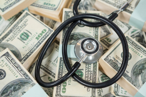 Bundled payments in healthcare Stethoscope on top of bundles of money