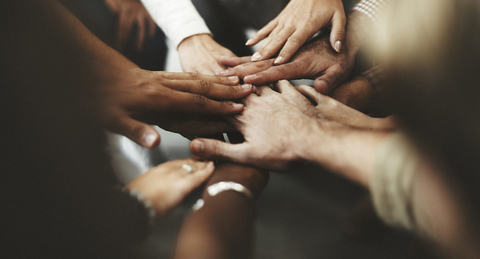 Diversity concept hands stacked on top of each other Diverse concept hands on top of one another