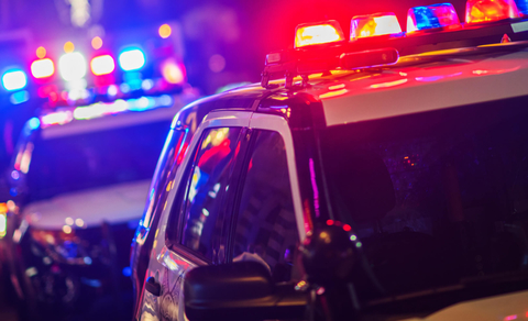 Two police vehicles at night with lights on Two law enforcement vehicles with lights on at night