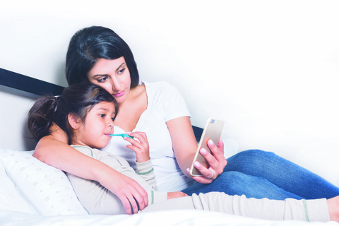 Kinsa smart thermometers in use/mom and daughter Kinsa smart thermometers