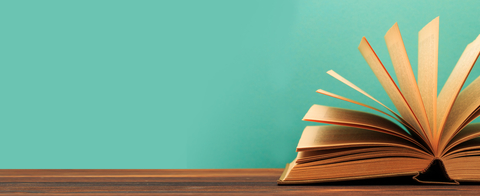 Open hardcover book Open book with pages fanned against a turquoise background