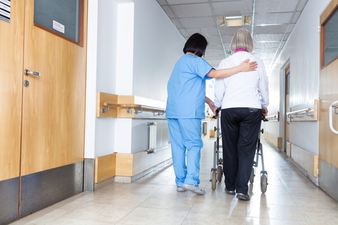 Skilled nursing facility A senior woman and female nurse in the hallway of a nursing home